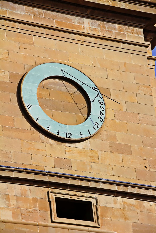 The sun dial on the right side of the church
