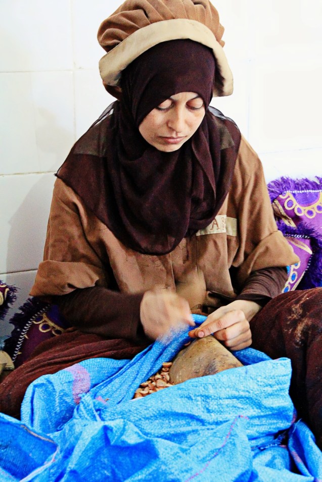 Cracking open the almond nuts for argan