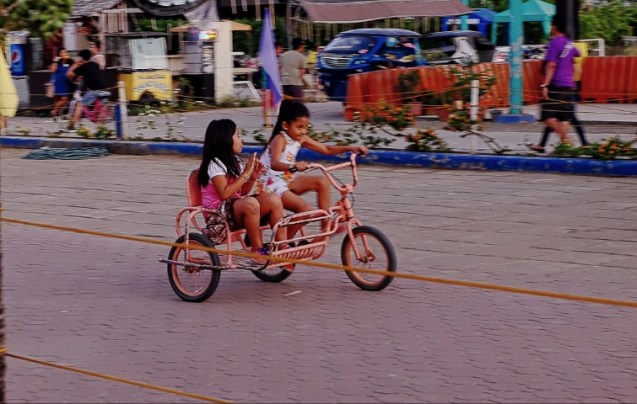 Baywalk bike path. Lots of kids enjoying bikes rented by parents